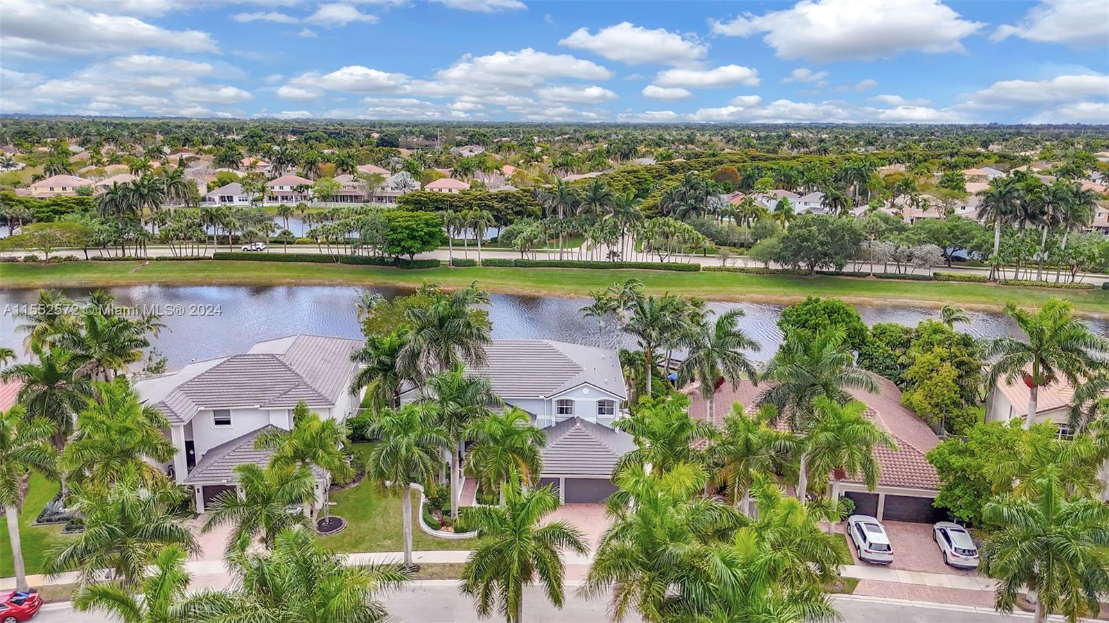 809 Regal Cove Road Weston, FL 33327 - Photo 3 of 70 an aerial view of residential houses with outdoor space and lake view