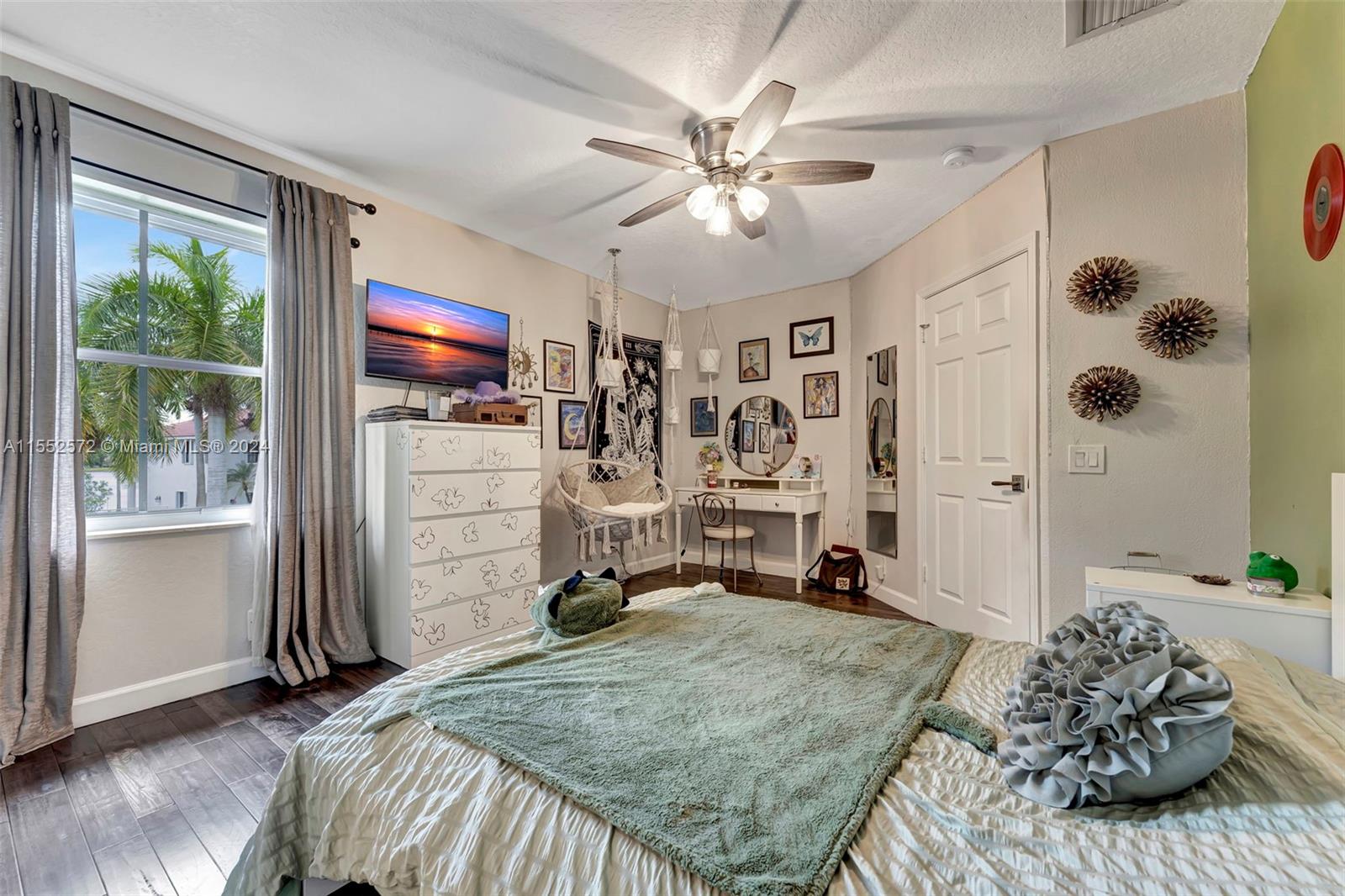 809 Regal Cove Road Weston, FL 33327 - Photo 34 of 70 a bedroom with a bed and a flat tv screen on dresser