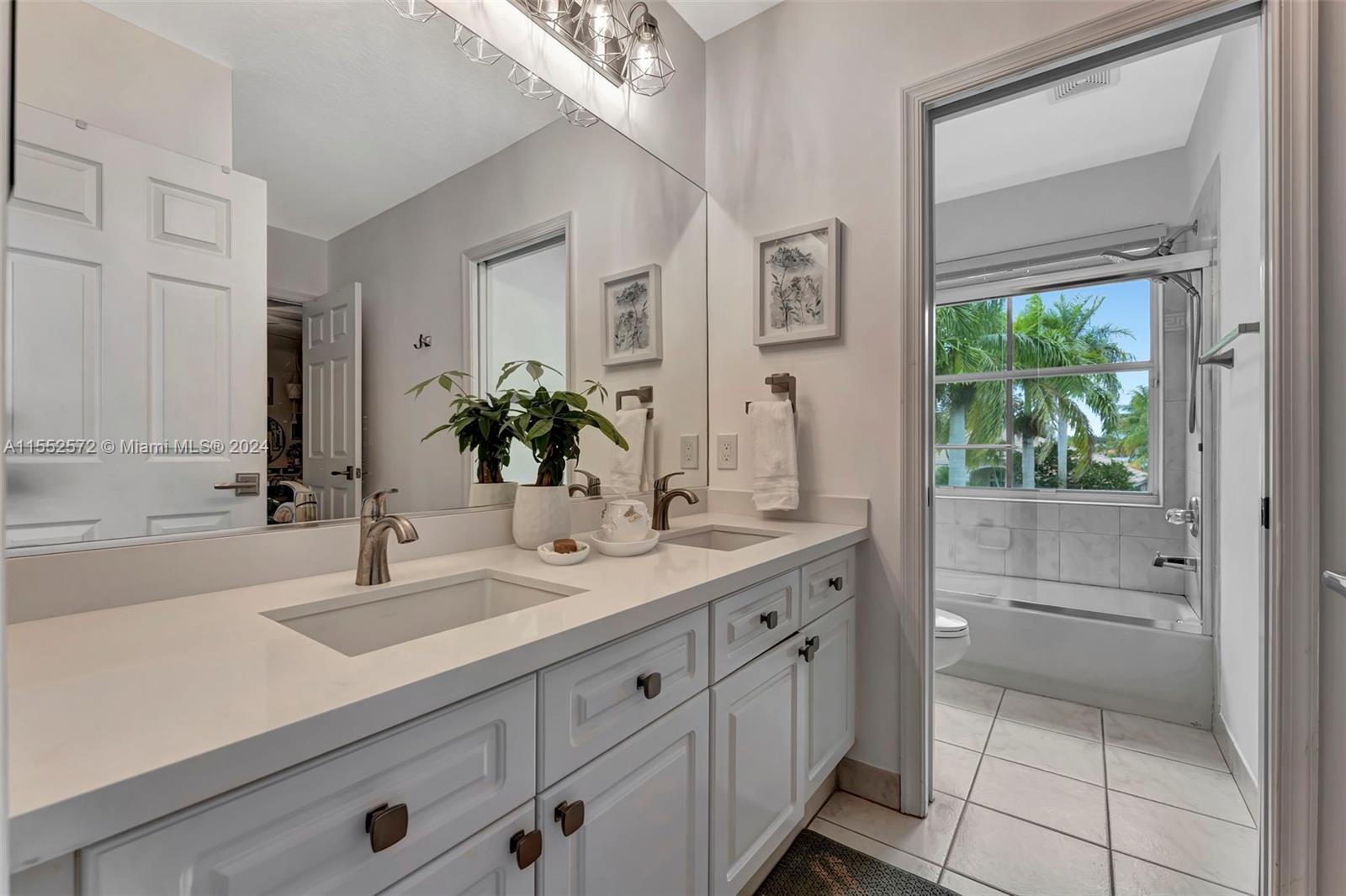 809 Regal Cove Road Weston, FL 33327 - Photo 35 of 70 a bathroom with a sink and a mirror