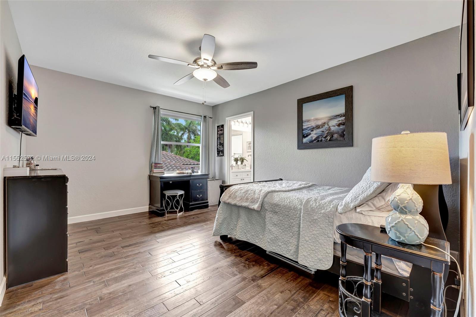 809 Regal Cove Road Weston, FL 33327 - Photo 38 of 70 a bedroom with a bed and wooden floor