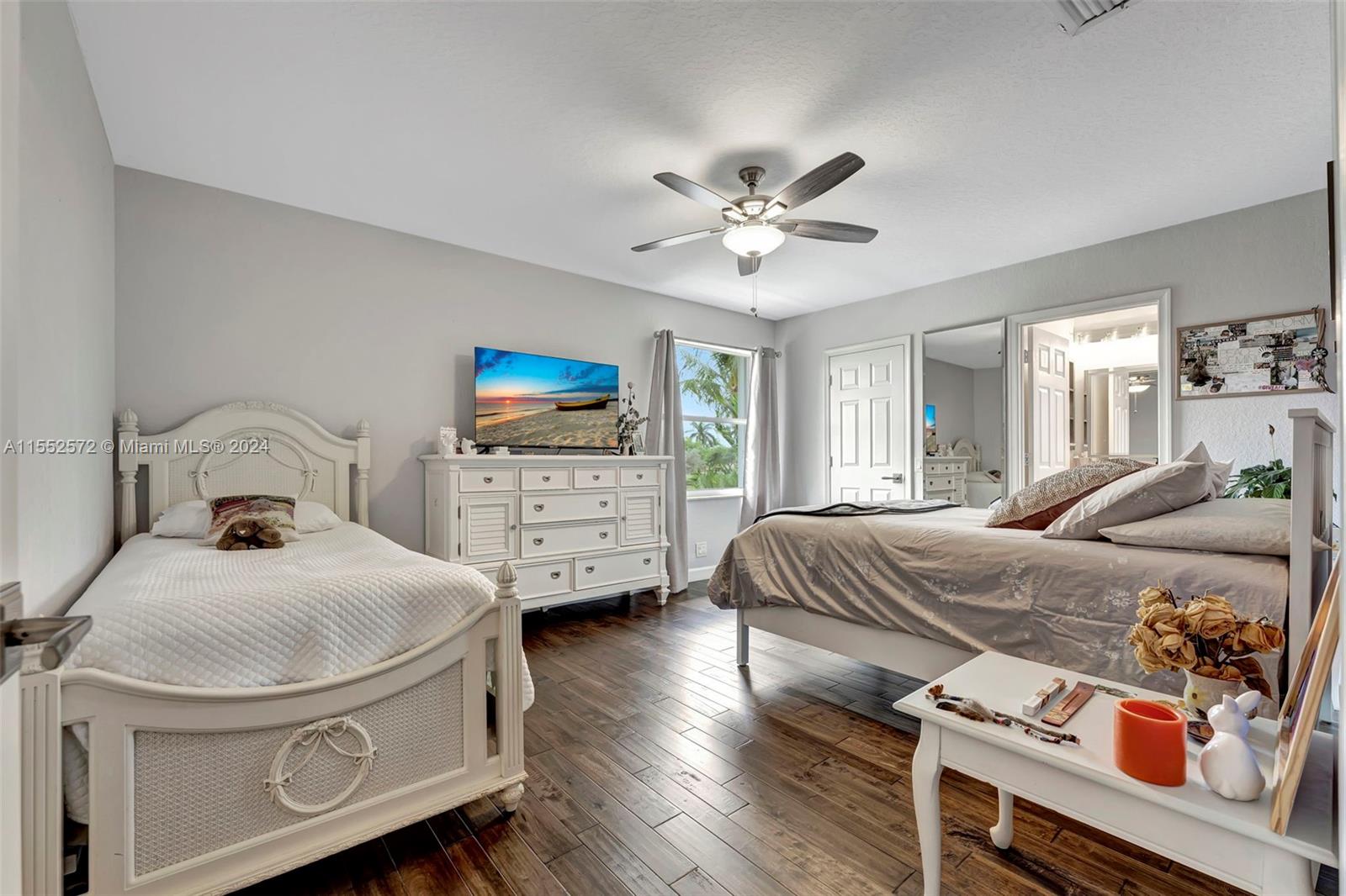 809 Regal Cove Road Weston, FL 33327 - Photo 39 of 70 a bedroom with a bed and a tv on dresser