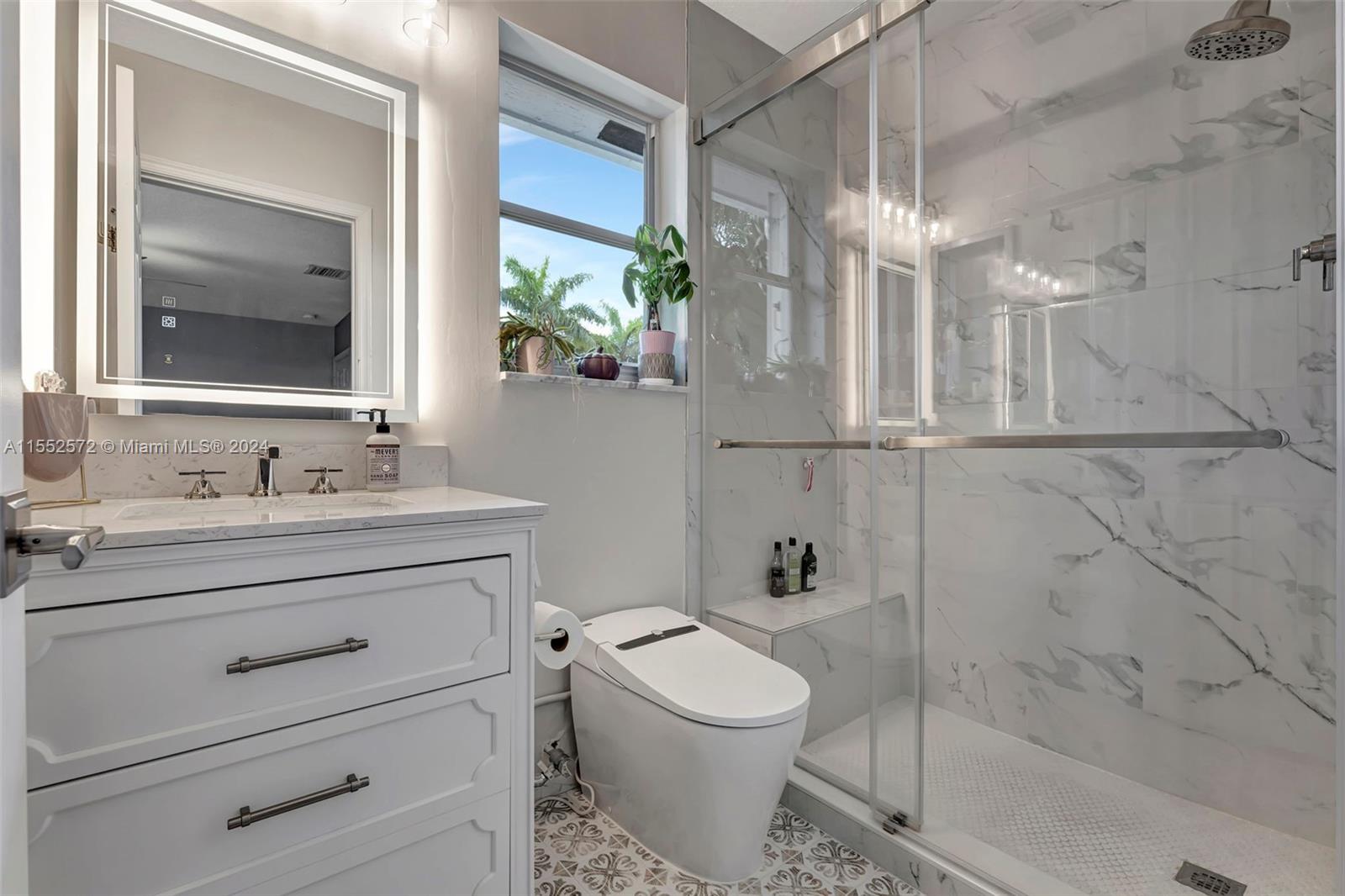 809 Regal Cove Road Weston, FL 33327 - Photo 41 of 70 a bathroom with a granite countertop toilet sink and mirror