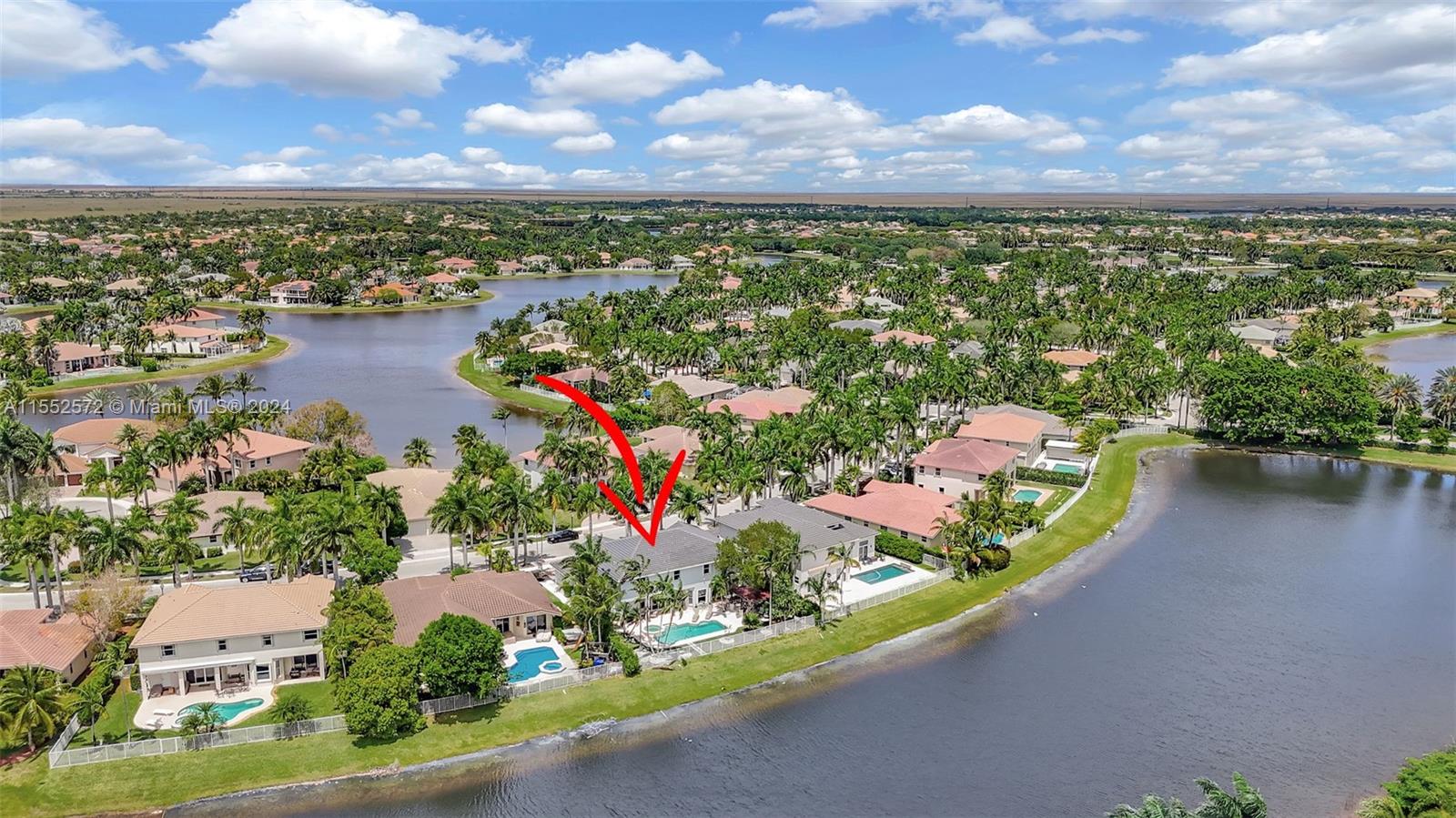 809 Regal Cove Road Weston, FL 33327 - Photo 5 of 70 an aerial view of a house with a garden and lake view