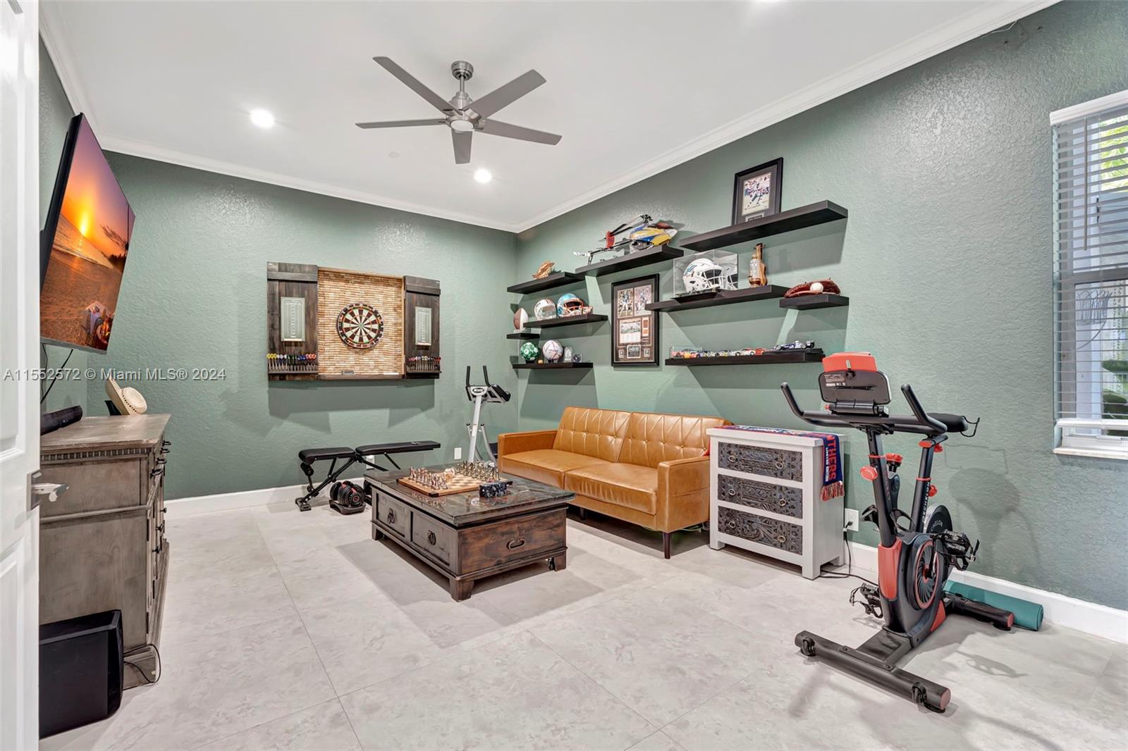 809 Regal Cove Road Weston, FL 33327 - Photo 52 of 70 a living room with furniture and a flat screen tv