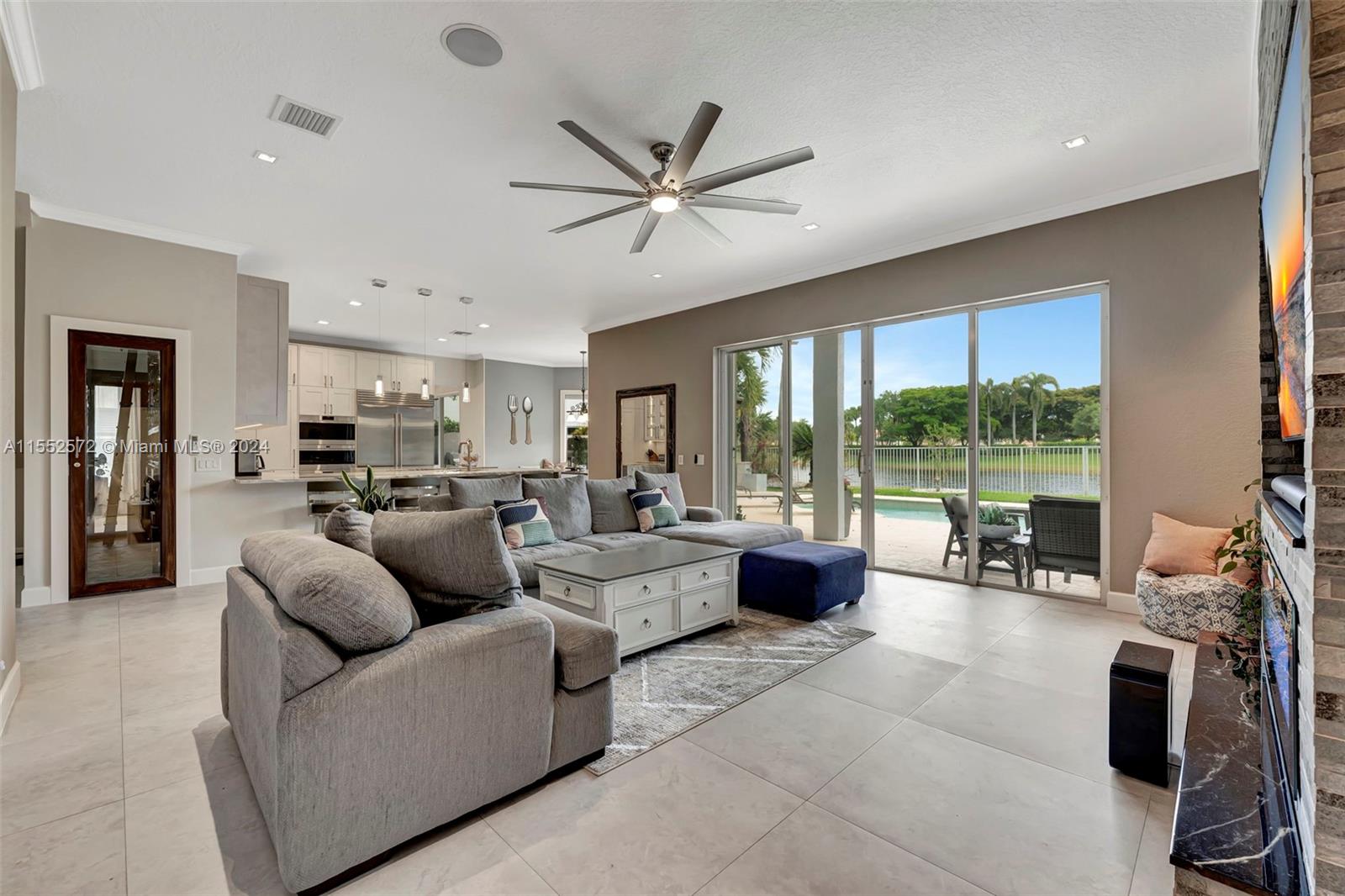 809 Regal Cove Road Weston, FL 33327 - Photo 54 of 70 a living room with furniture floor to ceiling window and a table