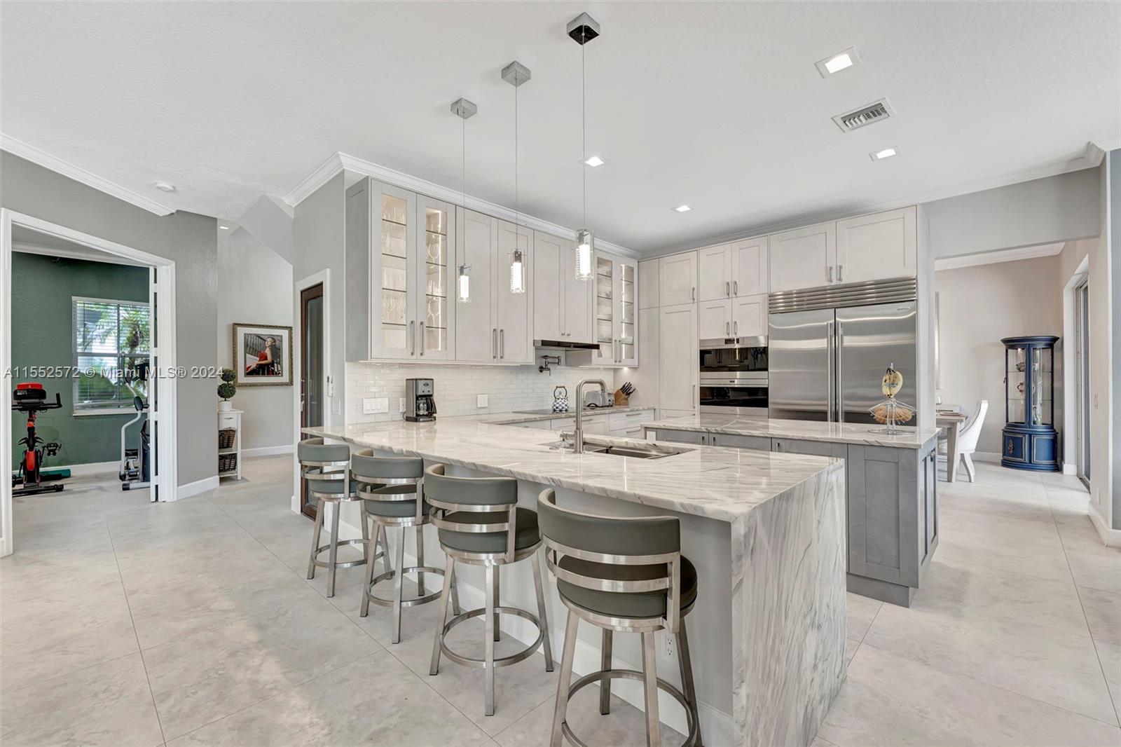 809 Regal Cove Road Weston, FL 33327 - Photo 56 of 70 a kitchen with cabinets a sink and chairs