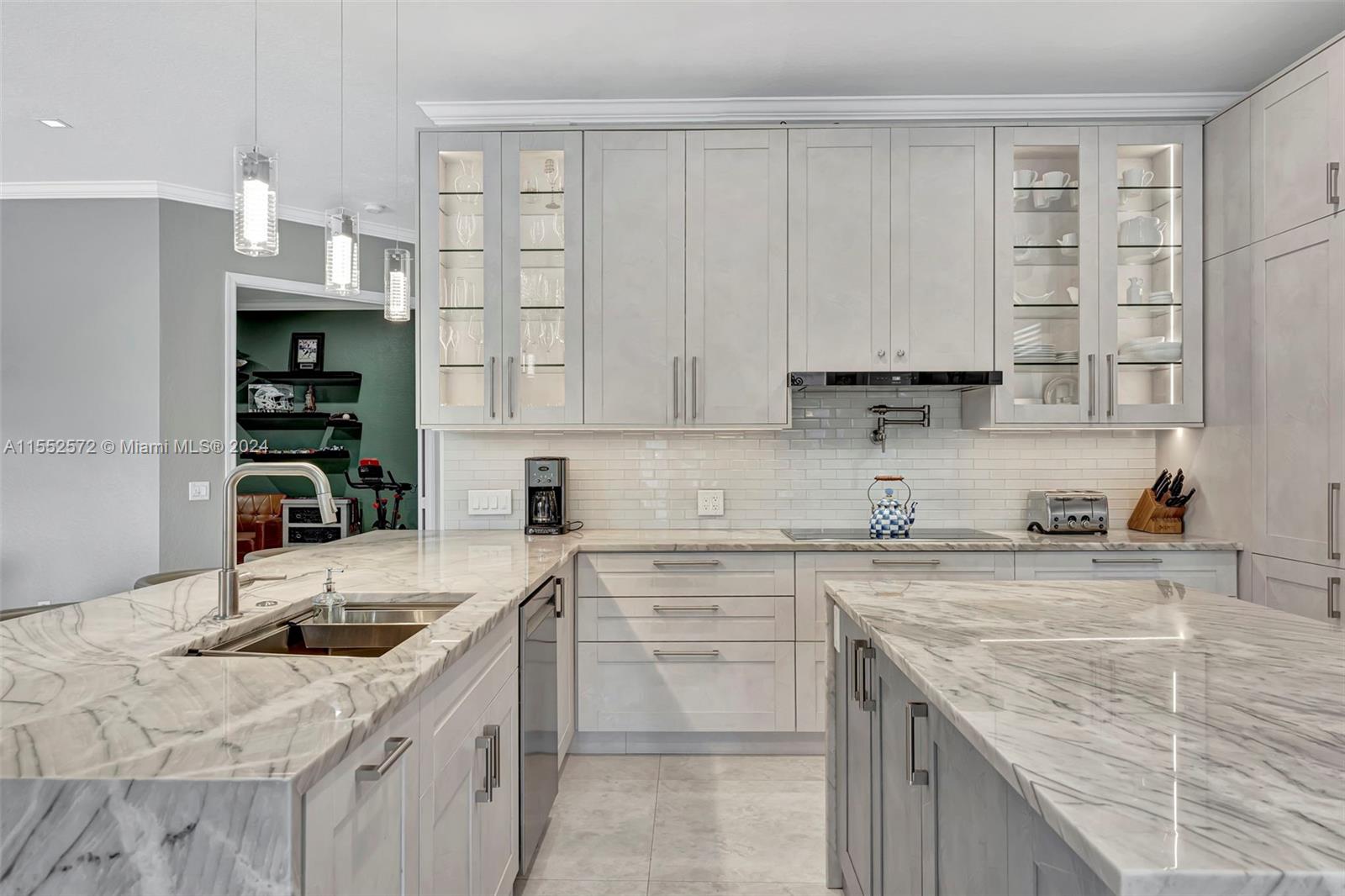 809 Regal Cove Road Weston, FL 33327 - Photo 59 of 70 a kitchen with stainless steel appliances granite countertop a sink stove and cabinets