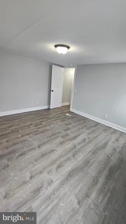 an empty room with wooden floor