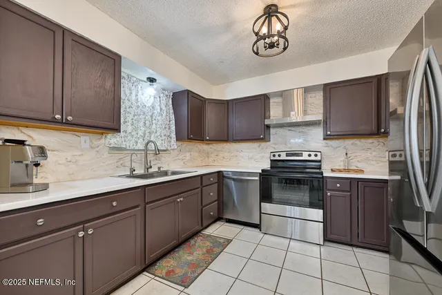 a kitchen with a sink cabinets and stainless steel appliances