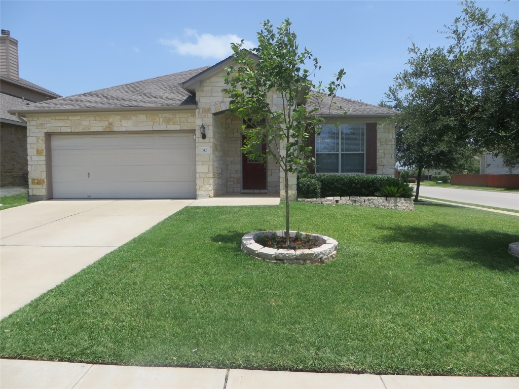 312 Saddle Ridge Drive Cedar Park, TX 78613 - Photo 1 of 1 a front view of a house with a yard