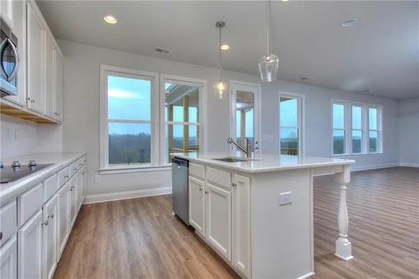 a bathroom with a vanity a sink a large mirror and a bathtub