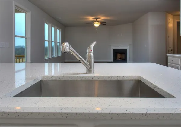 a view of a kitchen sink cabinet and a fireplace