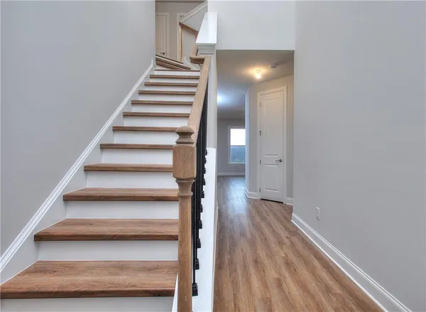 a view of an entryway with wooden floor