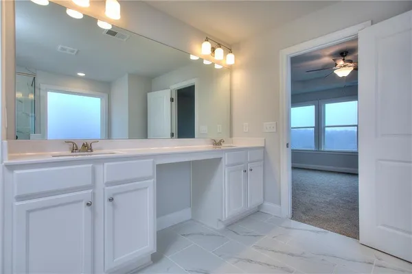 a bathroom with a double vanity sink and a mirror