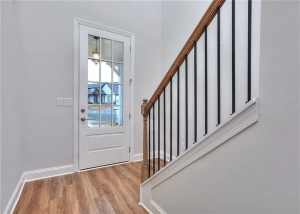 a view of a hallway with wooden floor and entryway
