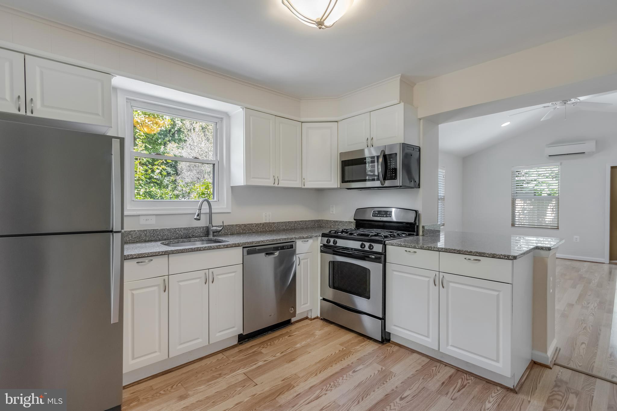 11603 Gail Street Silver Spring, MD 20902 - Photo 5 of 19 a kitchen with stainless steel appliances granite countertop a stove a sink and a refrigerator