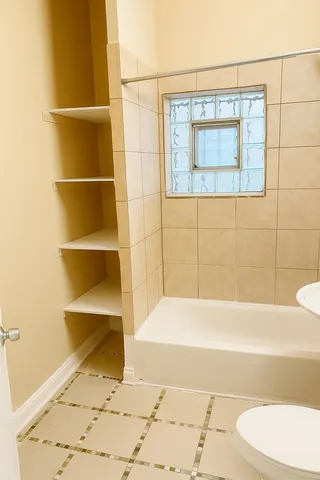 a bathroom with a bathtub and a shower