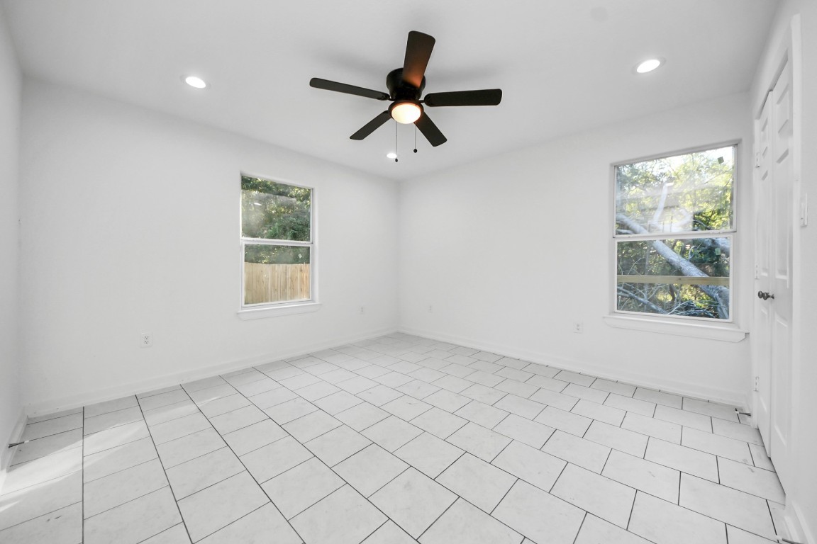 27090 Diamond C Splendora, TX 77372 - Photo 12 of 20 an empty room with windows and ceiling fan