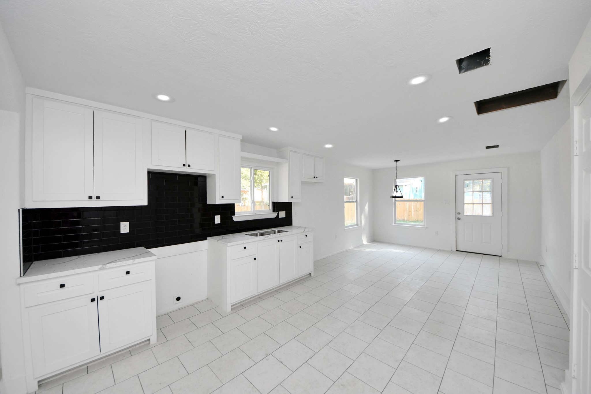 27090 Diamond C Splendora, TX 77372 - Photo 3 of 20 a kitchen with granite countertop white cabinets and black appliances