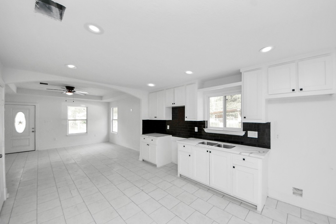 27090 Diamond C Splendora, TX 77372 - Photo 4 of 20 a kitchen with granite countertop white cabinets and sink
