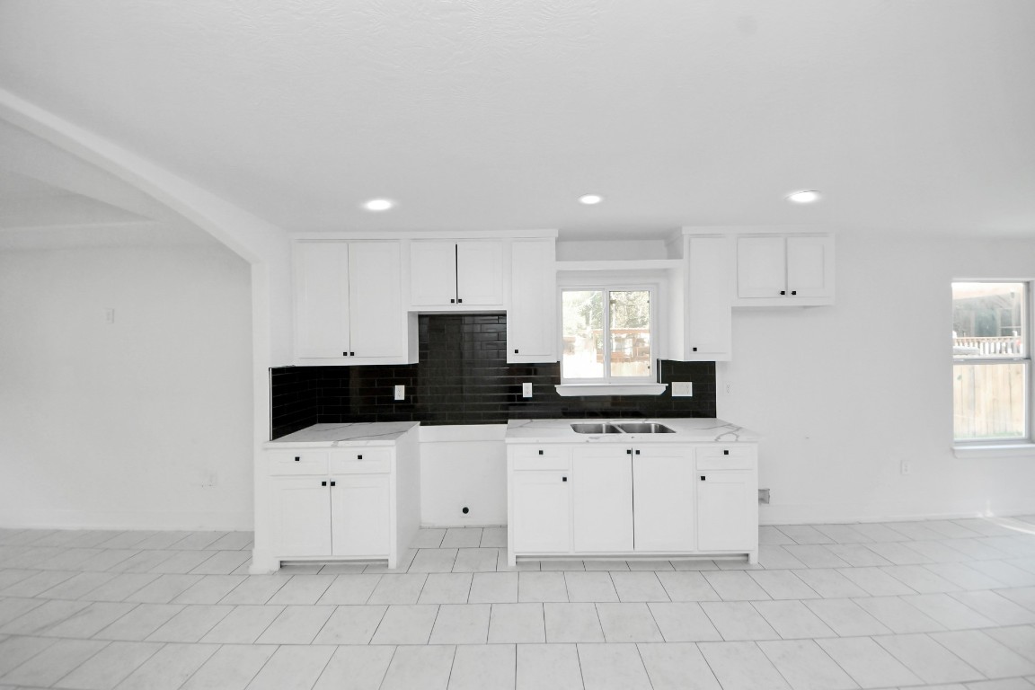 27090 Diamond C Splendora, TX 77372 - Photo 5 of 20 a kitchen with granite countertop a sink a stove a microwave and cabinets