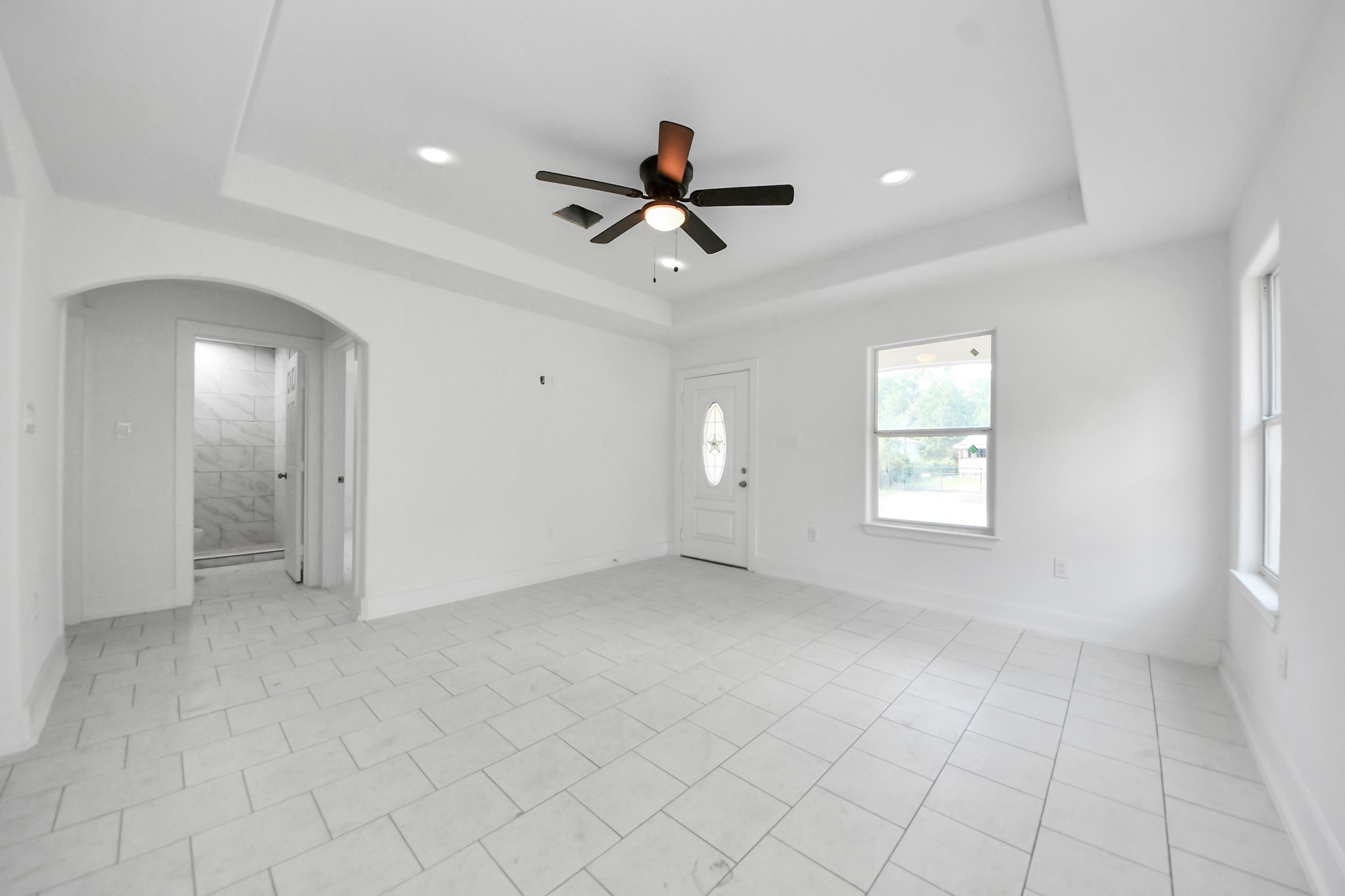 27090 Diamond C Splendora, TX 77372 - Photo 7 of 20 an empty room with windows and fan