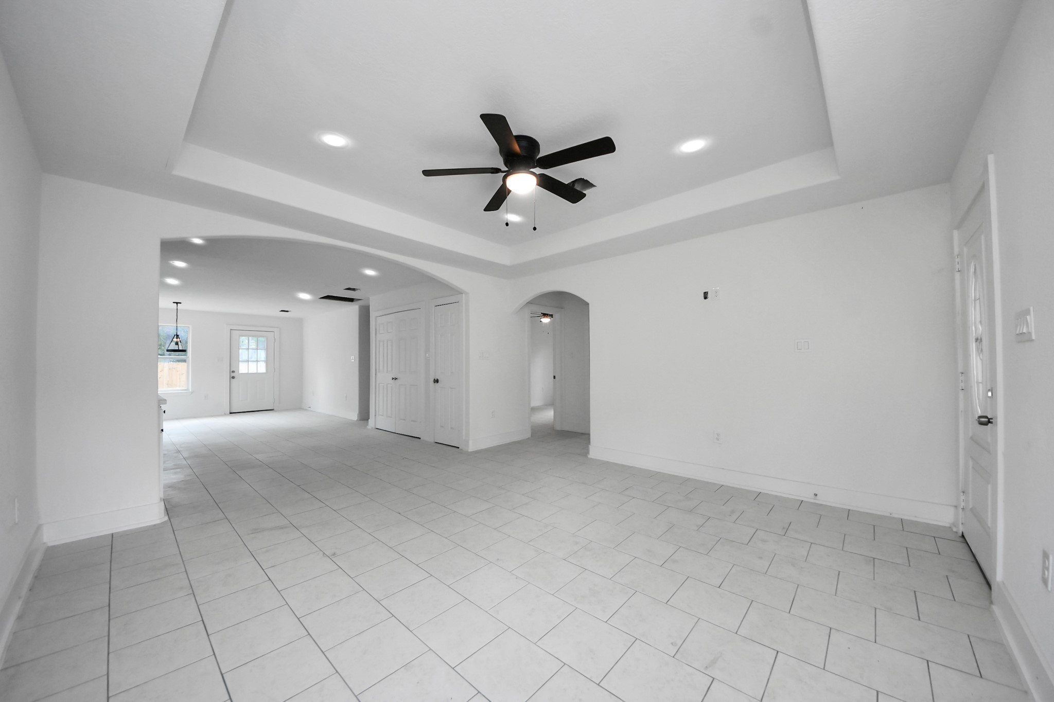 27090 Diamond C Splendora, TX 77372 - Photo 9 of 20 an empty room with chandelier fan and windows