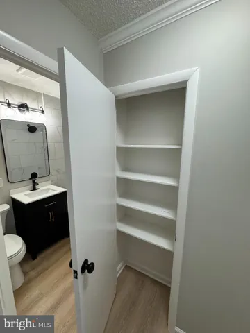 a bathroom with a sink vanity mirror and toilet