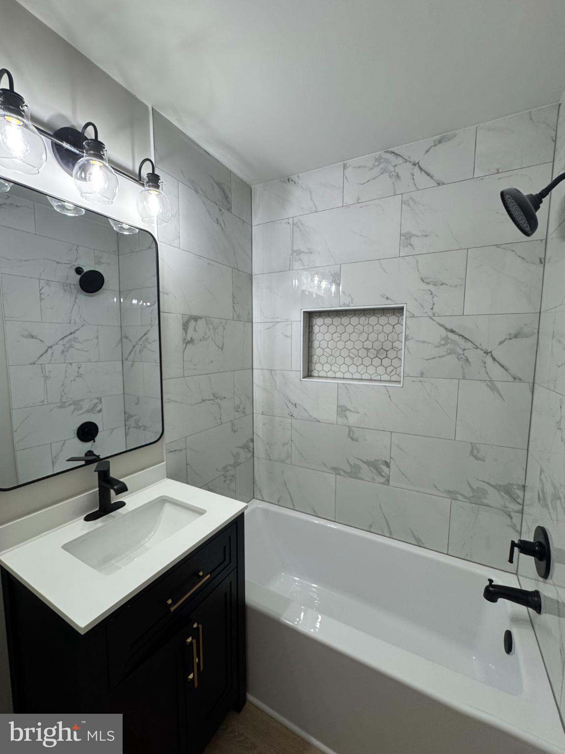 3801 Swann Road, Unit 303 Suitland, MD 20746 - Photo 19 of 19 a bathroom with a sink mirror toilet and bathtub