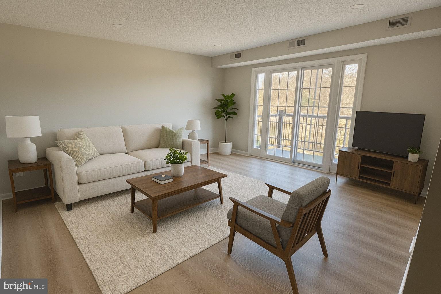 3801 Swann Road, Unit 303 Suitland, MD 20746 - Photo 3 of 20 Living room and balcony. AI staged.