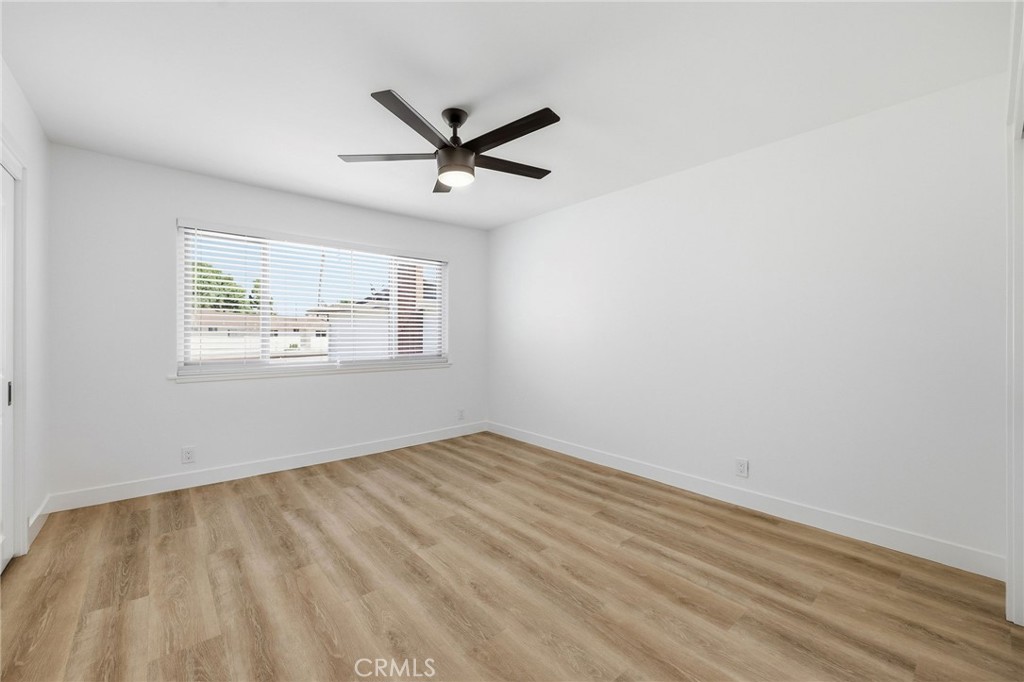 1722 Mitchell, Unit 152 Tustin, CA 92780 - Photo 11 of 25 a view of empty room with wooden floor and fan