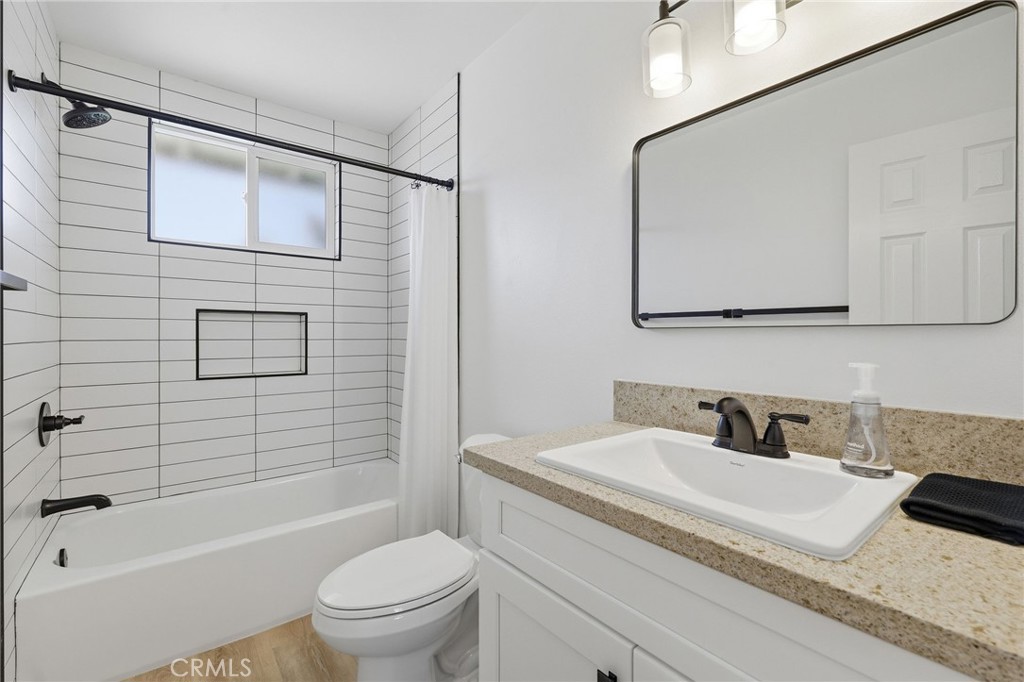 1722 Mitchell, Unit 152 Tustin, CA 92780 - Photo 15 of 25 a bathroom with a granite countertop sink toilet and shower