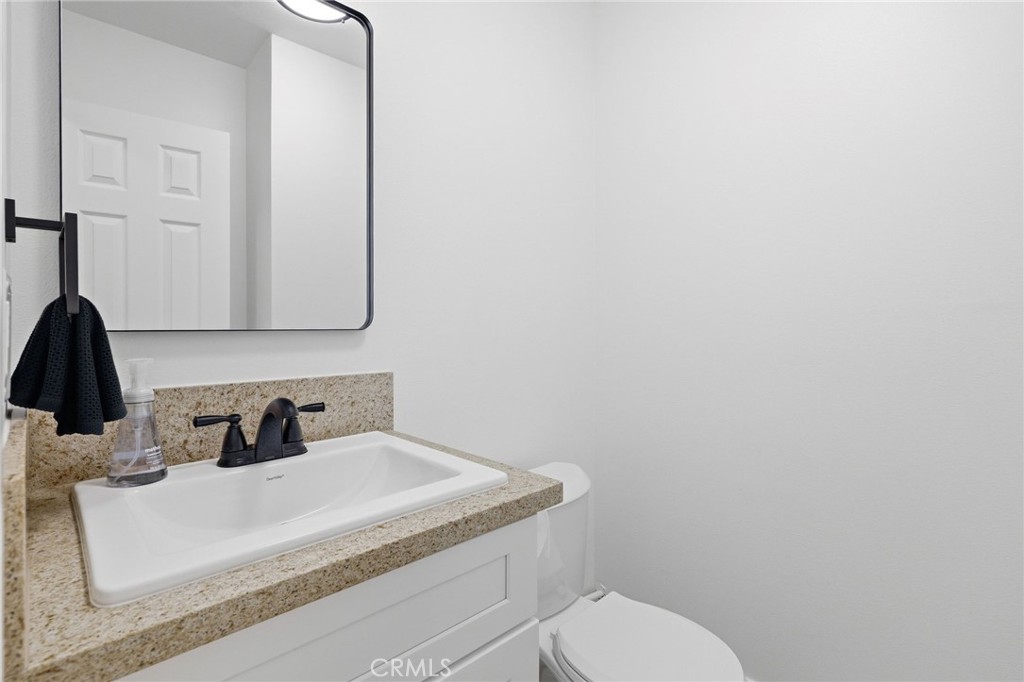 1722 Mitchell, Unit 152 Tustin, CA 92780 - Photo 16 of 25 a bathroom with a toilet sink and mirror