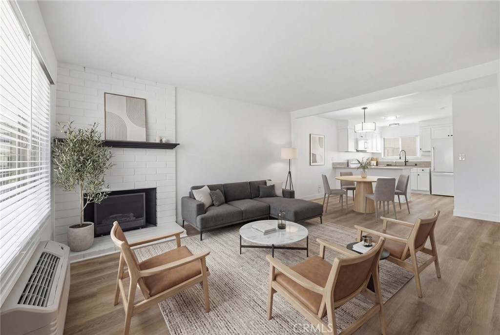 1722 Mitchell, Unit 152 Tustin, CA 92780 - Photo 3 of 25 a living room with furniture a fireplace and a window