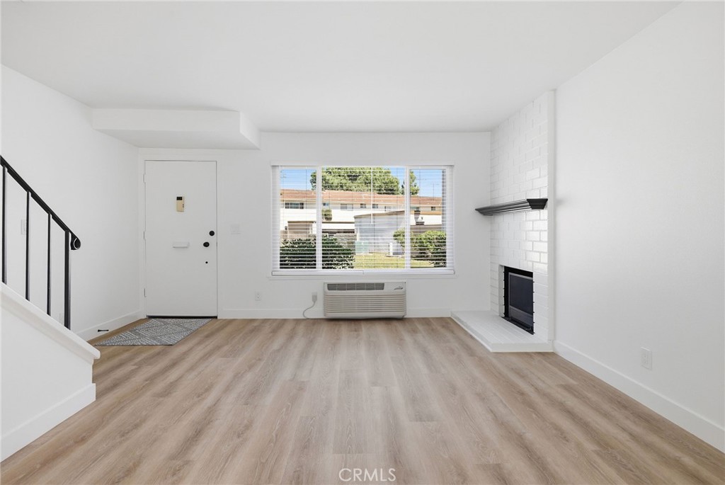 1722 Mitchell, Unit 152 Tustin, CA 92780 - Photo 5 of 25 wooden floor in an empty room with a window