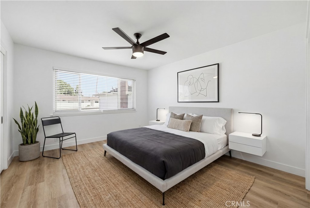 1722 Mitchell, Unit 152 Tustin, CA 92780 - Photo 10 of 25 a living room with a bed furniture and a window