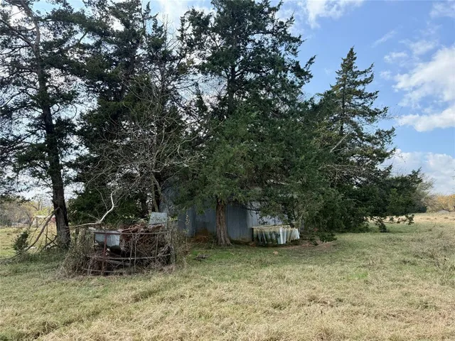 a backyard of a house with barbeque oven and outdoor seating