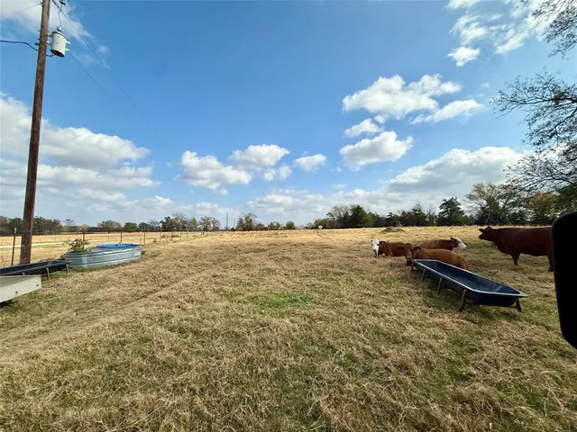 a view of a lake with lawn chairs