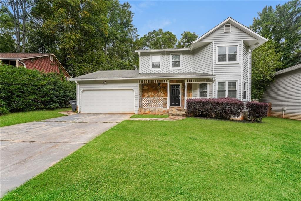980 Memory Lane Lawrenceville, GA 30044 - Photo 1 of 1 a front view of a house with a yard and trees