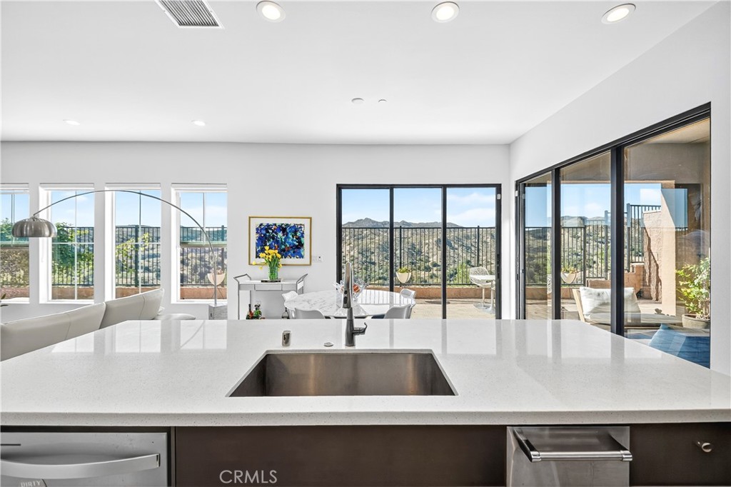 a kitchen with a large window and a sink