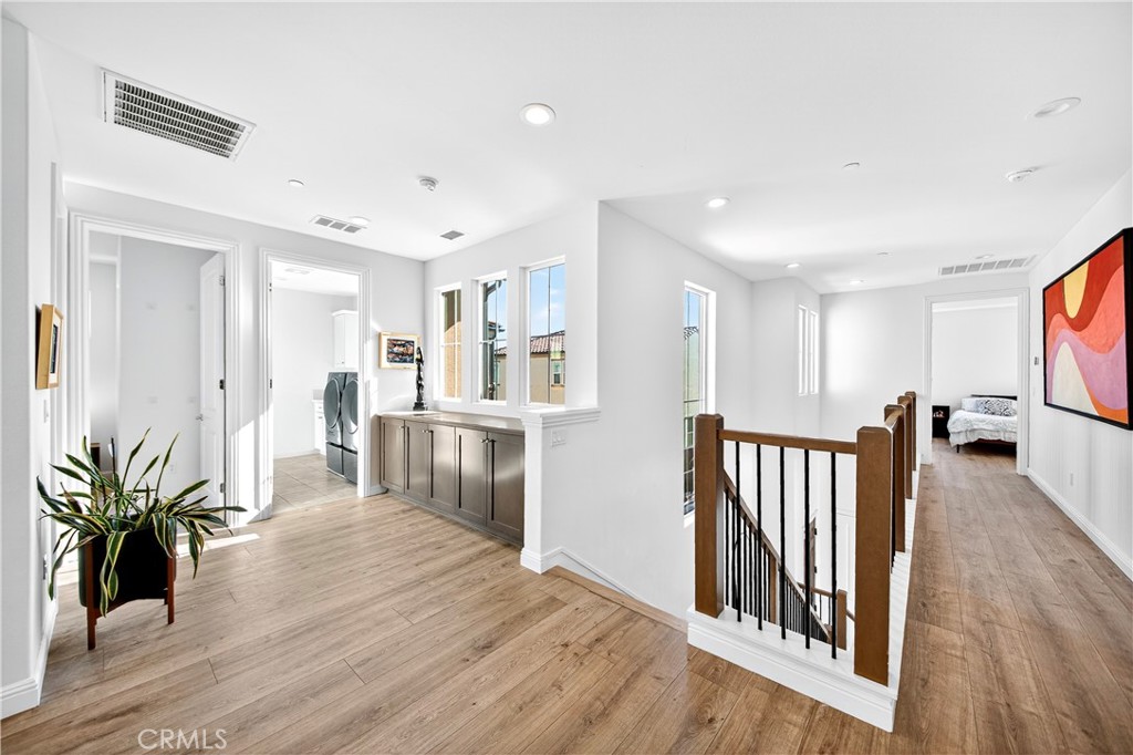 20851 Acorn Circle Porter Ranch, CA 91326 - Photo 13 of 26 a view of a hallway with wooden floor and a living room