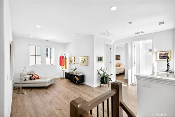 a bedroom with furniture and a wooden floor