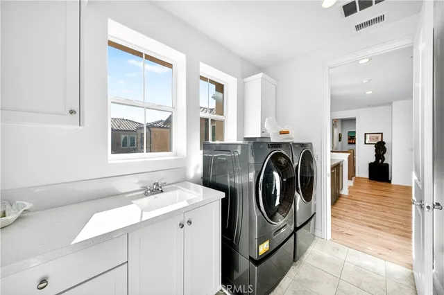a view of a kitchen with sink washer and dryer