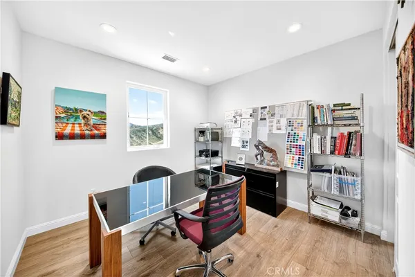 a workspace with furniture and wooden floor