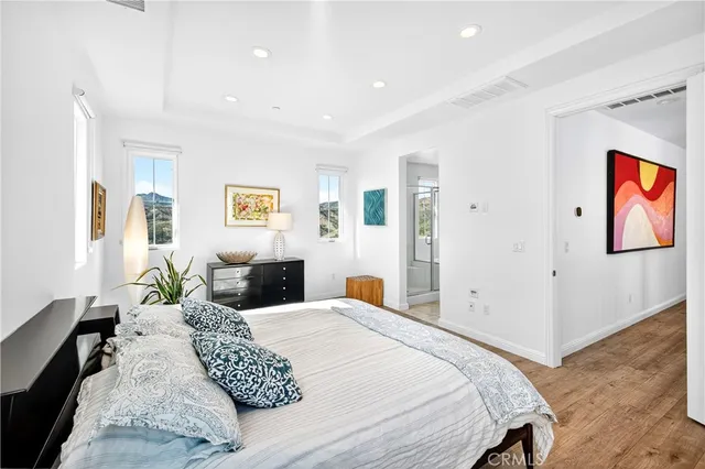 a bedroom with a large bed and a chandelier