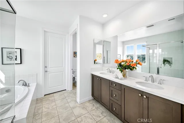 a spacious bathroom with a double vanity sink and a