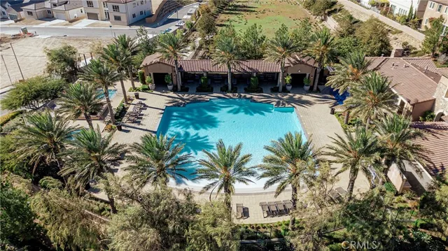 a view of a house with pool and sitting area