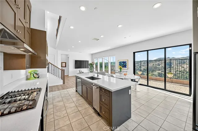 a large white kitchen with a large window