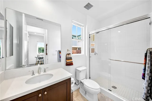 a bathroom with a sink toilet vanity and shower