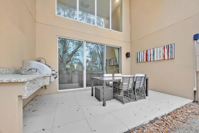 a dining room with furniture and a floor to ceiling window